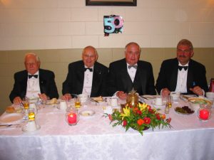 50 Years of Reciprocal Visiting. L to r: V.W. Bro John Gilpin, Member of Nickel and Friendship Lodges; V.W. Bro. Milt Fleming, Grand Steward; W. Bro. Brian Howe, WM Nickel Lodge No. 427; W. Bro. Brian Post, WM Friendship Lodge No. 691.