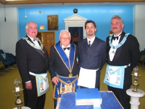 50th Reciprocal Visit - The Meeting. The Masters of Nickel and Friendship Lodge flank our senior and newest members.