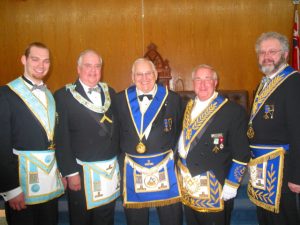 September - The Grand Steward receives congratulations from the W.M., D.D.G.M., his son R.W. Bro. Fleming and his grandson, Bro. Steve Fleming.