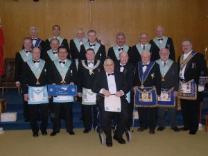 November Emergent Meeting. Bro. Fred Kirk received his Second Degree during the Annual Reciprocal Visit of Friendship Lodge No. 691. Pictured with Bro. Kirk are the Officers of Friendship Lodge, the Worshipful Master of Nickel Lodge, the District Secretary and the DDGM.