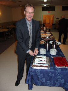 Bro. John Mason gets things started by cutting his cake.