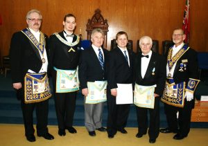 D.D.G.M. Official Visit - March 6th. Initiation of Mr. Phillipe Ruff. His Grandfather, Bro. Paul Ruff presented him with the Working Tools and his Uncle, Bro. Paul Ruff Jr. of Gothic Lodge No. 608 gave the Charge. L to r: sponsor R.W. Bro. Rob Fleming; W. Bro. Stephen R. Fleming; Bro. Paul Ruff Jr.; newly initiated Bro. Phillipe Ruff; sponsor Bro. Paul Ruff Sr.; R.W. Bro. Keith I. Jordan, D.D.G.M.