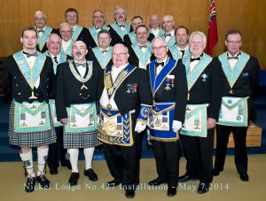 The Worshipful Master and the newly Invested Officers for 2014-2015. Front row: SW W. Bro. Stephen Fleming; WM W. Bro. Thomas E. King; DDGM R.W. Bro. L. Clair Bracken; GS V.W. Bro. Alan Farquharson; JW W. Bro. Gregory L. Newson; SD Bro. John Mason. Second row: Proxy W. Bro. Brian Howe; IPM V.W. Bro. Clive D. Stephenson; Proxy W. Bro. David Kennedy; SS Bro. Glenn Mersereau. Third row: DC R.W. Bro. J.David Innes; Chaplain W. Bro. Pavvo E. Liukko; JD Bro. John M. Reynolds. Back row: Tyler V.W. Bro. Robert Storie; IG Bro. Thomas F. Morris; Treasurer Bro. Michael Lalonde; Secretary R.W. Bro. Robert J. Fleming; Historian R.W. Bro. Robert South.