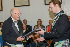 W. Bro. Grant Boyce, receiving his certificate from W. Bro. Stephen Fleming, W.M.