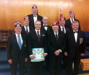 Raising of Bro. Jordan Douglas. Front row: Noble Barry Tooley, Bro. Jordan Douglas, Nobles Nels Conroy and Reijo Luoma. Back row: Nobles Harley Allman, Rob Fleming, Gary Cayen, Charles Searle and Stan Fenton.